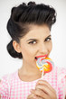 Cute young pinup biting a lollipop