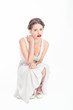 Fresh teen with red lipstick crouched