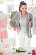 Cheerful fashion designer writing a text message