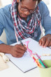 Concentrated artistic man drawing clothes