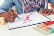 Artistic man drawing clothes in his studio