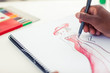 Man drawing clothes with a pencil