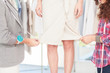 Fashion designers adjusting a dress