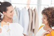Attractive woman showing her new dress to a friend