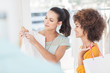 Woman showing her new dress to a friend