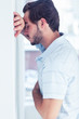 Stressed man leaning against a wall