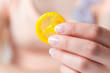 Woman holding condom in hand