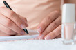 Young female is writing notes