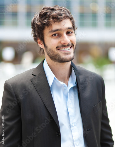 Photo: Handsome young businessman in an urban setting Handsome young businessman in an urban setting