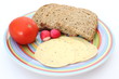 Slices of bread, tomato, cheese and radish on the plate