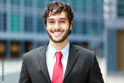 Photo: Handsome young businessman in an urban setting Handsome young businessman in an urban setting