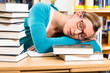Photo: student in library asleep over books student in library asleep over books