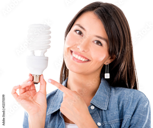 Photo: Woman with an energy saving lightbulb Woman with an energy saving lightbulb