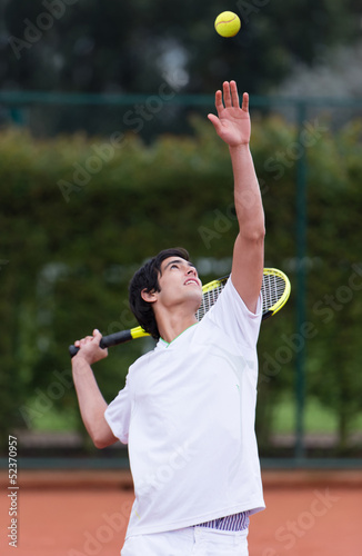 Photo: Man serving at tennis Man serving at tennis