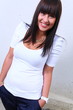 Photo: pretty girl standing in front of wall pretty girl standing in front of wall