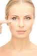 beautiful woman touching her eye area