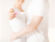 woman and man hands with pregnancy test