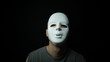Scary masked man over dark background
