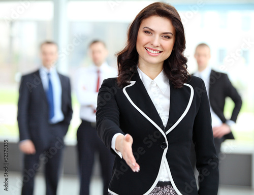 Photo: Portrait of a woman with an open hand ready to seal a deal Portrait of a woman with an open hand ready to seal a deal