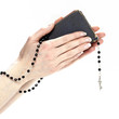 Hands holding the Bible and praying with a rosary