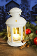 Beautiful white lantern on snowy evening landscape. Christmas de