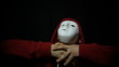 Insane masked man over dark background