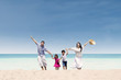Happy family running at beach