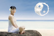 Photo: Happy girl and ying yang cloud at beach Happy girl and ying yang cloud at beach