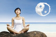 Photo: Asian woman meditate under yin yang cloud Asian woman meditate under yin yang cloud