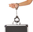 case of money and handcuffs with hand, isolated