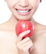 young woman eating red apple with health teeth