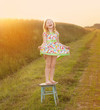 Photo: happy girl on chair outdoor happy girl on chair outdoor
