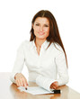 A young woman at the desk with papers