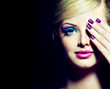 Blonde model with fashion make-up and violet manicure