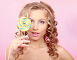 young happy woman with lollipop, isolated on pink background