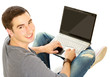 Photo: Positive young man studying on floor Positive young man studying on floor