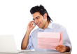 A young man talking on the phone and holding papers
