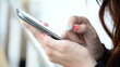 Close up beautiful young woman using a smartphone