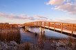wooden bridge over river at sunrise