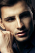 Portrait of handsome young man, sexy guy looking at camera