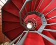 Iron spiral staircase with elegant red carpet and spiral
