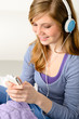 Pretty teenage girl listening to music