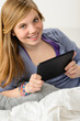 Happy young girl using digital tablet