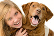 Adolescent girl embracing her golden retriever