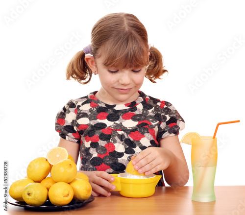 Photo: beautiful little girl make lemonade beautiful little girl make lemonade