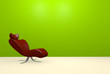 Modern red chair on a green wall