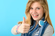 Cheerful teenage girl showing thumbs up