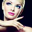 Blonde model with fashion make-up and violet manicure