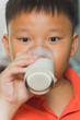 Photo: Young Asian boy with a glass of milk Young Asian boy with a glass of milk