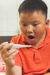 Photo: Young asian child with a digital thermometer Young asian child with a digital thermometer